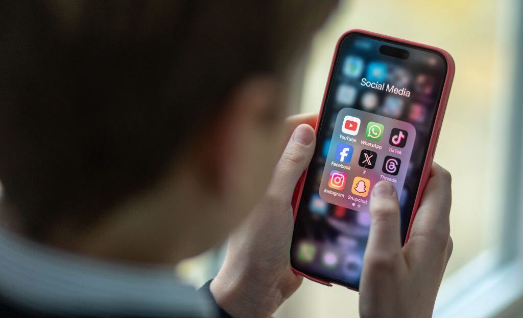 iPhone screen showing various social media apps including TikTok, Facebook and X. (Matt Cardy/Getty Images)