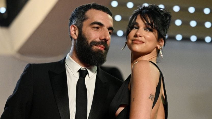 TOPSHOT - French director Romain Gavras (L) and British singer and model Dua Lipa arrive for the screening of the film "Omar la Fraise" (The King of Algiers) during the 76th edition of the Cannes Film Festival in Cannes, southern France, on May 20, 2023. (Photo by Patricia DE MELO MOREIRA / AFP) (Photo by PATRICIA DE MELO MOREIRA/AFP via Getty Images)