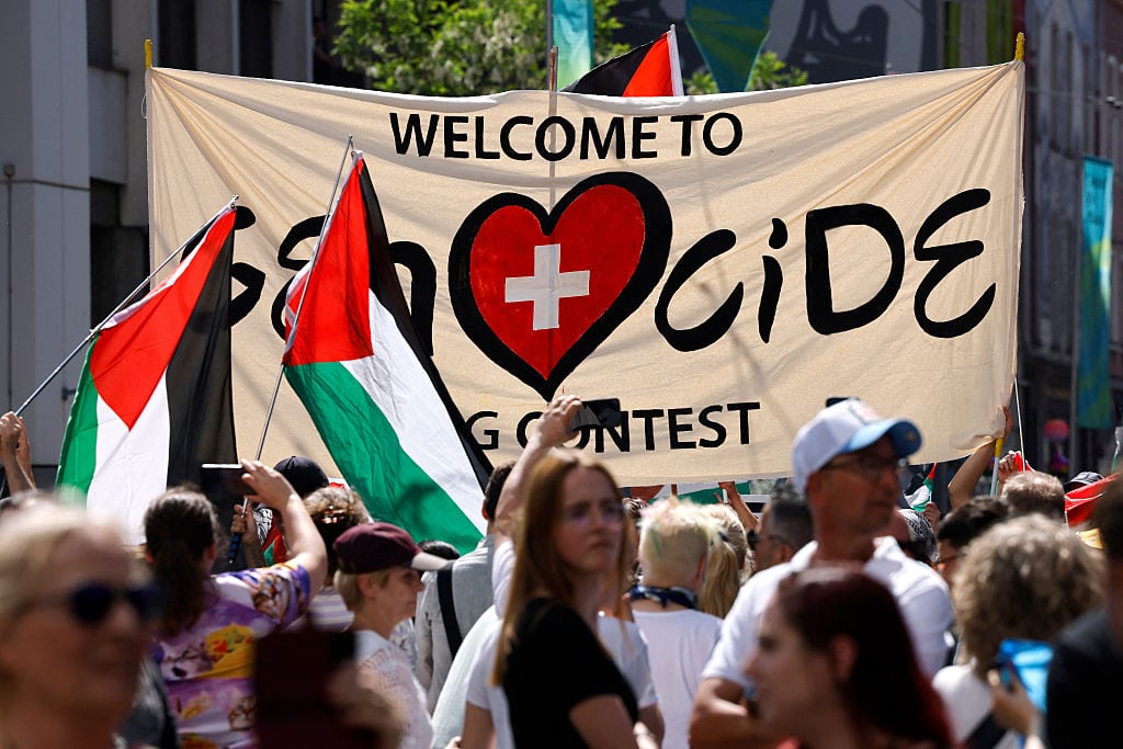Protestors hold Palestinian flags and a banner as they take part in a demonstration against Israel’s candidate and during the Eurovision Song Contest 2025 opening ceremony in Basel on May 11, 2025. Stefan Wermuth / AFP) (Photo by STEFAN WERMUTH/AFP via Getty Images