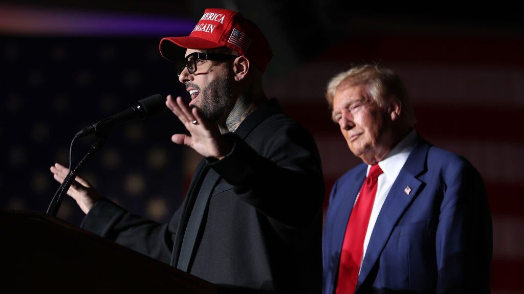 Nicky Jam (L) speaks as Republican presidential nominee, former U.S. President Donald Trump, (R) looks on during a campaign rally at The Expo at World Market Center Las Vegas on September 13, 2024 in Las Vegas, Nevada. With 53 days before election day, Former President Trump continues to campaign. Justin Sullivan/Getty Images