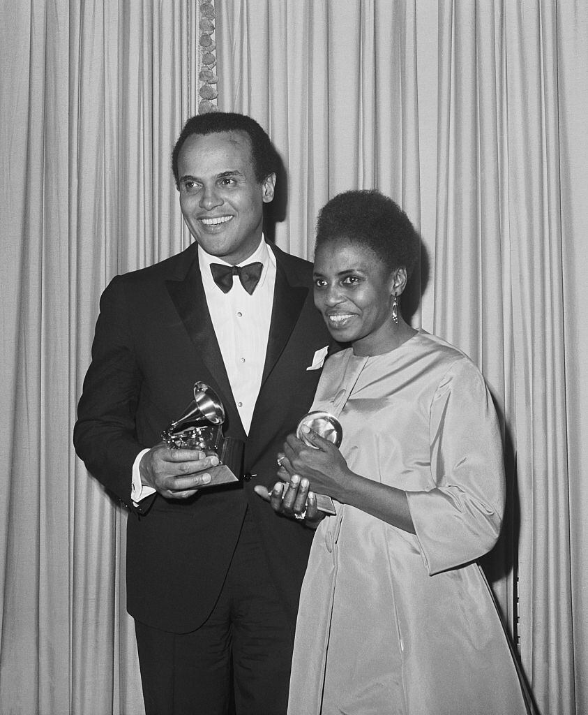 A portrait of Harry Belafonte and Miriam Makeba holding their Grammy awards for Best Folk Record. Photo: Getty.
