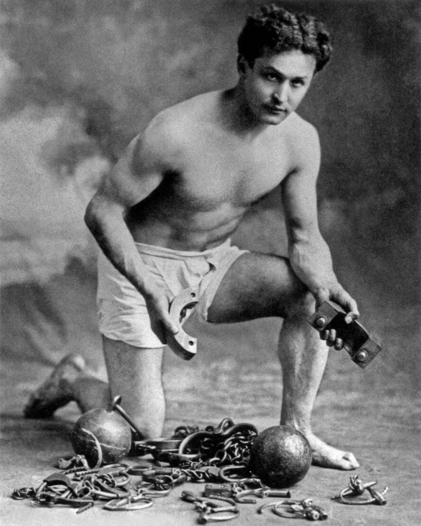 Harry Houdini (1874-1926), here with chains, c. 1906. Getty Images.