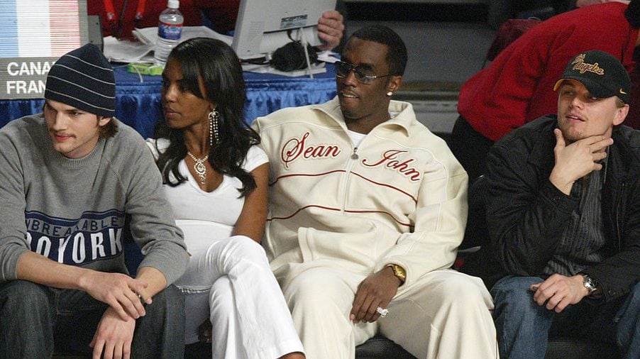 Actor Ashton Kutcher, Kim Porter, music producer Sean «P Diddy» Combs and actor Leonardo DiCaprio attend the 2004 NBA All-Star Game held at the Staples Center, February 15, 2004 in Los Angeles, California. Vince Bucci/Getty Images