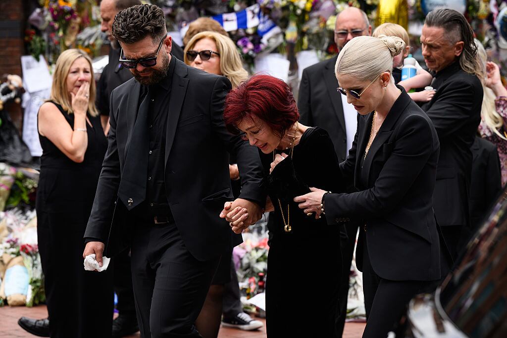 Jack Osbourne, Sharon Osbourne and Kelly Osbourne leave after viewing tributes to the late Ozzy Osbourne from fans as his funeral cortege travels through his home city of Birmingham on July 30, 2025 in Birmingham, England. (Leon Neal/Getty Images)