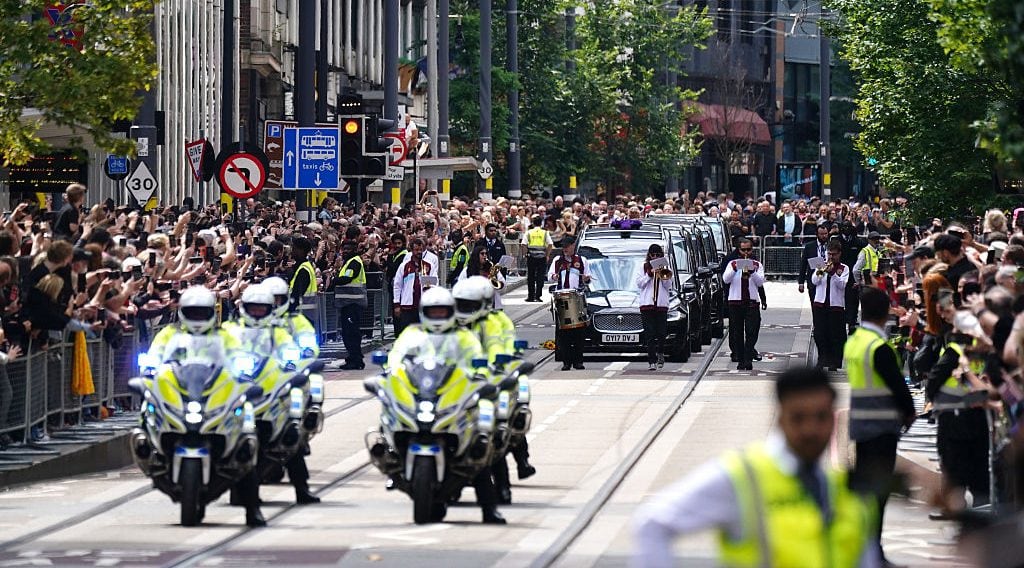 The funeral cortege of Black Sabbath frontman Ozzy Osbourne travels along Broad Street in Birmingham, as his body is brought back to his home city following his death last week aged 76. (Jacob King/Getty Images)
