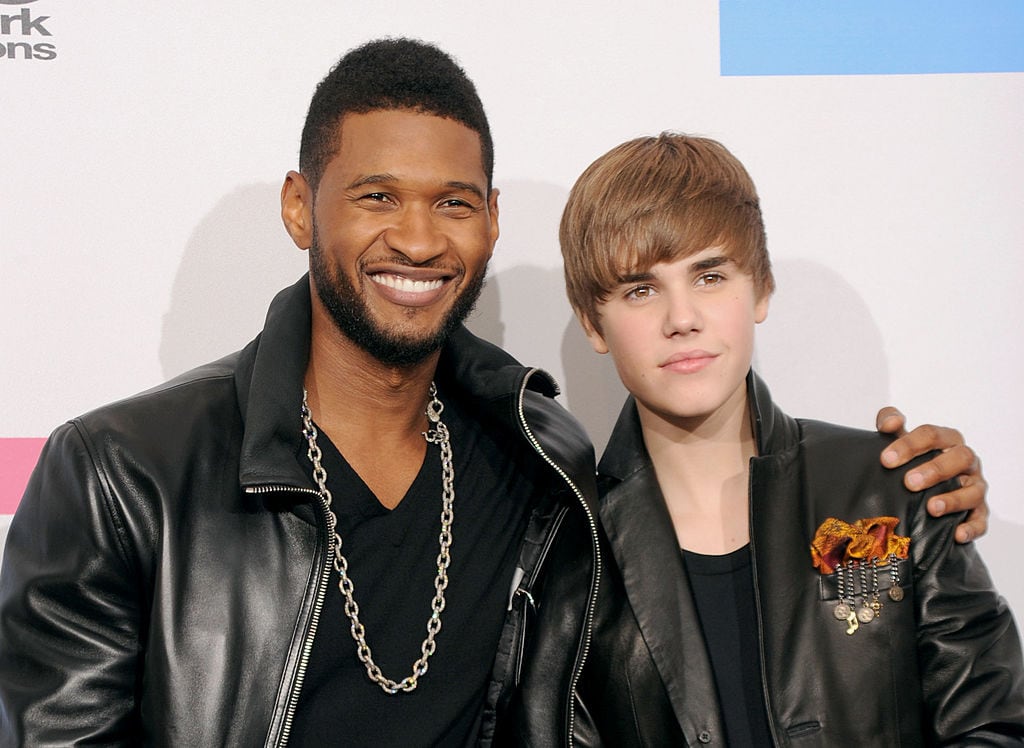 Usher, winner of Soul/R&B Favorite Album Award and Soul/R&B Favorite Male Artist Award with Justin Bieber, winner of T-Mobile Breakthrough Artist Award, Pop/Rock Favorite Male Artist Award and Artist Of The Year Award, pose in the press room during the 2010 American Music Awards held at Nokia Theatre L.A. Live on November 21, 2010 in Los Angeles, California. Jason Merritt/Getty Images for DCP