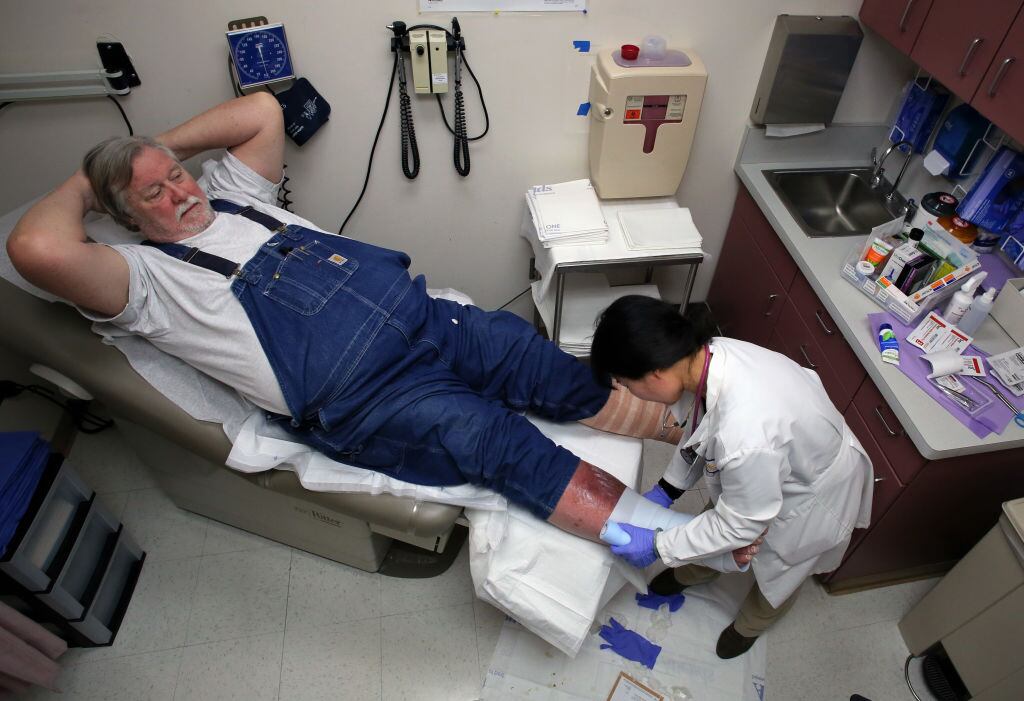 Paul Haskins, who has venous insufficiency is tended to by nurse practitioner Yuwen Liao at the San Mateo Medical Center in San Mateo, Ca., on Thurs. March 23, 2017. (Michael Macor/Getty Images)