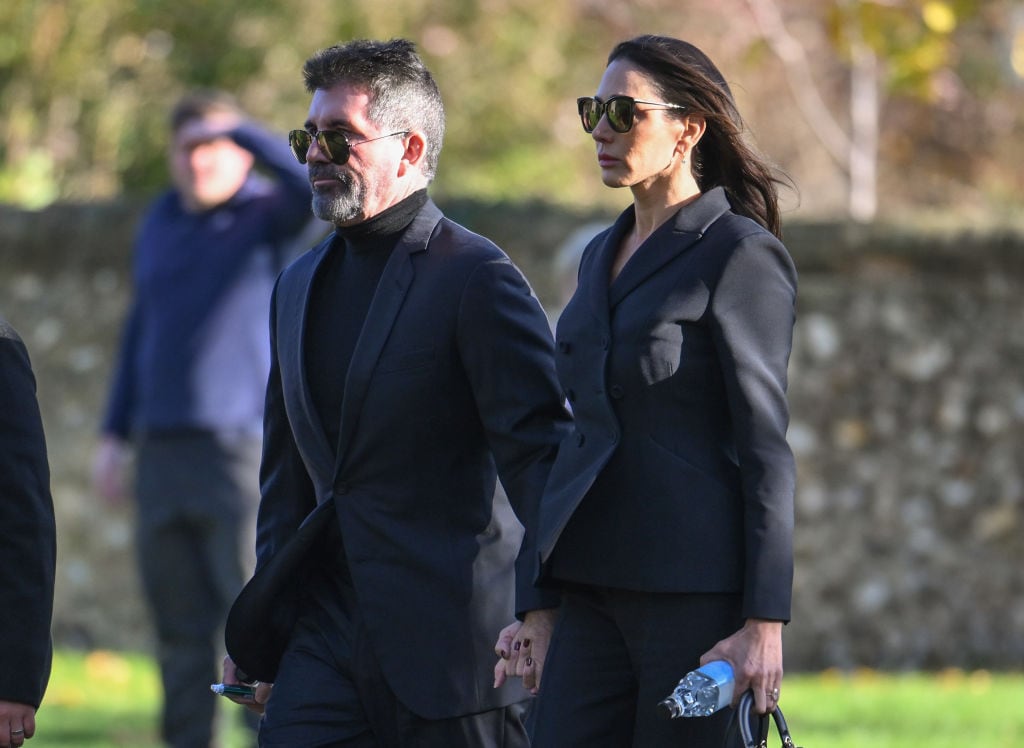 AMERSHAM, ENGLAND – NOVEMBER 20: Simon Cowell and Lauren Silverman attend the funeral for singer Liam Payne, former member of One Direction, on November 20, 2024 in Amersham, England. Former One Direction star Liam Payne’s private funeral in Amersham has been widely anticipated to draw celebrities and fans alike, wishing to pay their final respects. The singer died after falling from a hotel balcony in Buenos Aires on October 16. (Photo by Karwai Tang/WireImage)