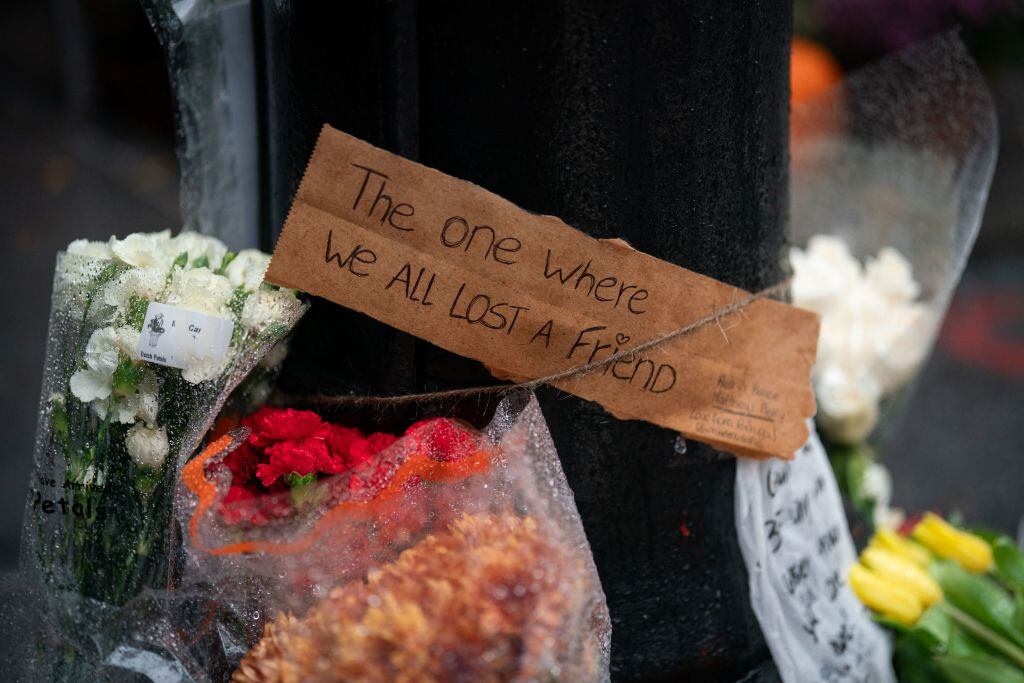 Floral tributes are left for actor Matthew Perry outside the apartment building which was used as the exterior shot in the TV show «Friends» in New York on October 29, 2023. Adam GRAY/AFP via Getty Images