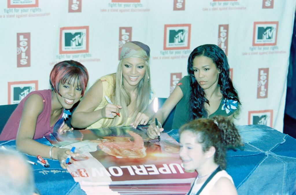 Kelly Rowland, Beyonce Knowles, and Michelle Rowland of Destiny’s Child sign autographs at the Original Levi’s Store, Manhattan. Thomas Iannaccone/WWD/Penske Media via Getty Images
