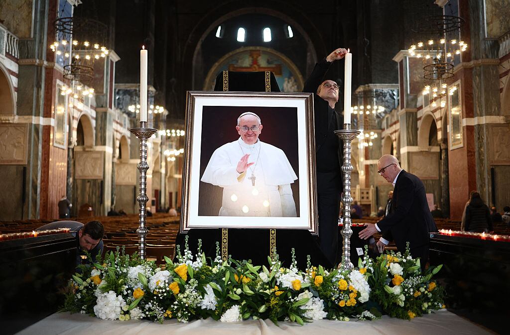 Cathedral staff set up an image of Pope Francis inside The Metropolitan Cathedral of the Most Precious Blood, informally known as Westminster Cathedral, in central London on April 21, 2025, following the news of his death. Pope Francis died on April 21, 2025 aged 88, a day after making a much hoped-for appearance at Saint Peter’s Square on Easter Sunday, the Vatican said in a statement. HENRY NICHOLLS / AFP