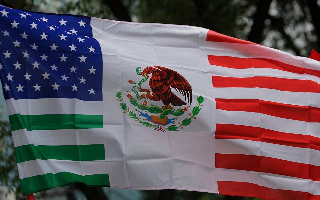 A view of a United States flag fused with the Mexican flag, which American citizens living in Mexico use to protest against US President Donald Trump, who since the beginning of his term orders the detention and mass deportation of migrants in the United States and border areas. (Gerardo Vieyra/Getty Images)