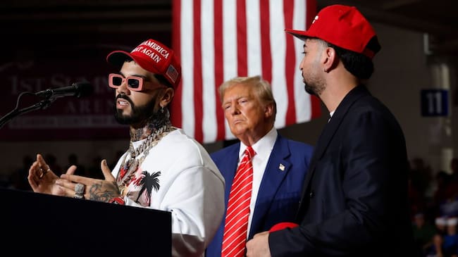 Anuel AA (L) joins Republican presidential nominee, former U.S. President Donald Trump during a campaign rally in the 1st Summit Arena at the Cambria County War Memorial on August 30, 2024 in Johnstown, Pennsylvania. Promising to cut energy bills in half, conduct the largest deportation operation in history and put a 200% tariff on foreign made automobiles, Trump rallied his supporters in the all-important battleground state of Pennsylvania. Chip Somodevilla/Getty Images