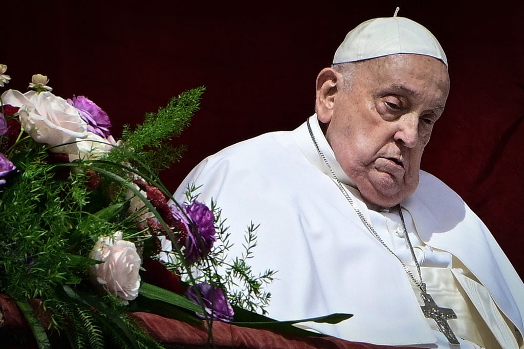Pope Francis stands at the main balcony of St. Peter’s basilica for the Urbi et Orbi message and blessing to the city and the world as part of Easter celebrations, at St Peter’s square in the Vatican on April 20, 2025. Tiziana FABI / AFP