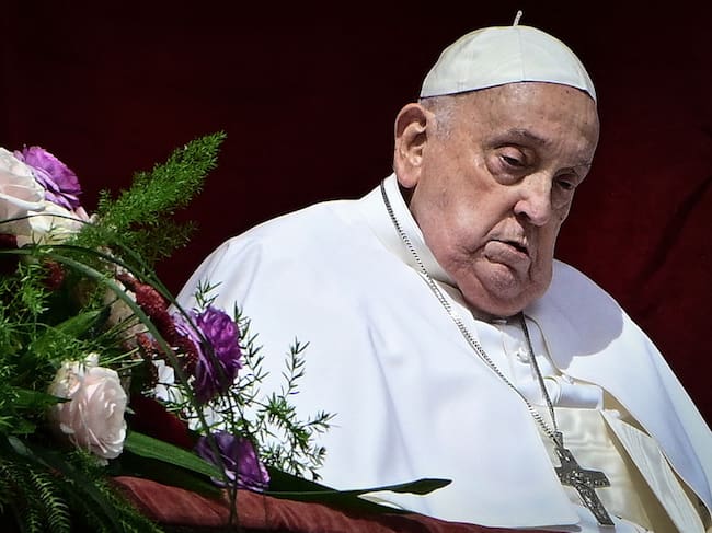 Pope Francis stands at the main balcony of St. Peter’s basilica for the Urbi et Orbi message and blessing to the city and the world as part of Easter celebrations, at St Peter’s square in the Vatican on April 20, 2025. Tiziana FABI / AFP