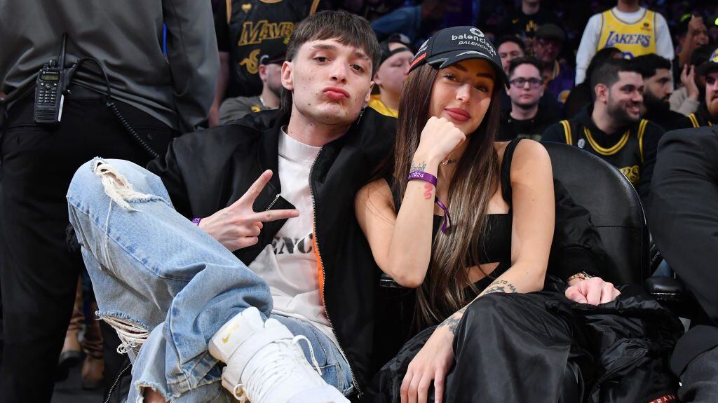 Peso Pluma and Nicki Nicole attend a basketball game between the Los Angeles Lakers and the Denver Nuggets at Crypto.com Arena on February 08, 2024 in Los Angeles, California. Allen Berezovsky/Getty Images