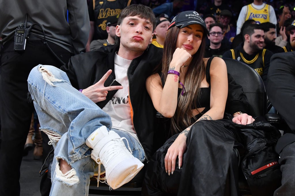 Peso Pluma and Nicki Nicole attend a basketball game between the Los Angeles Lakers and the Denver Nuggets at Crypto.com Arena on February 08, 2024 in Los Angeles, California. Allen Berezovsky/Getty Images