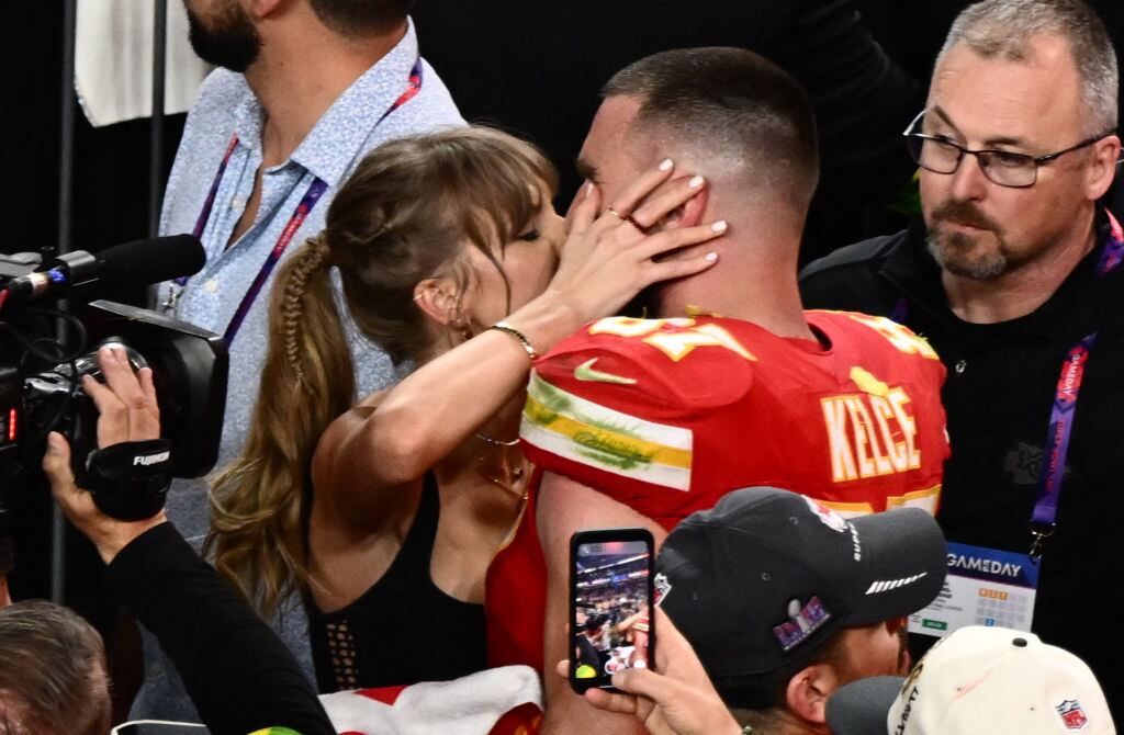 Taylor Swift kisses Kansas City Chiefs’ tight end #87 Travis Kelce after the Chiefs won Super Bowl LVIII against the San Francisco 49ers at Allegiant Stadium in Las Vegas, Nevada, February 11, 2024. PATRICK T. FALLON/AFP via Getty Images