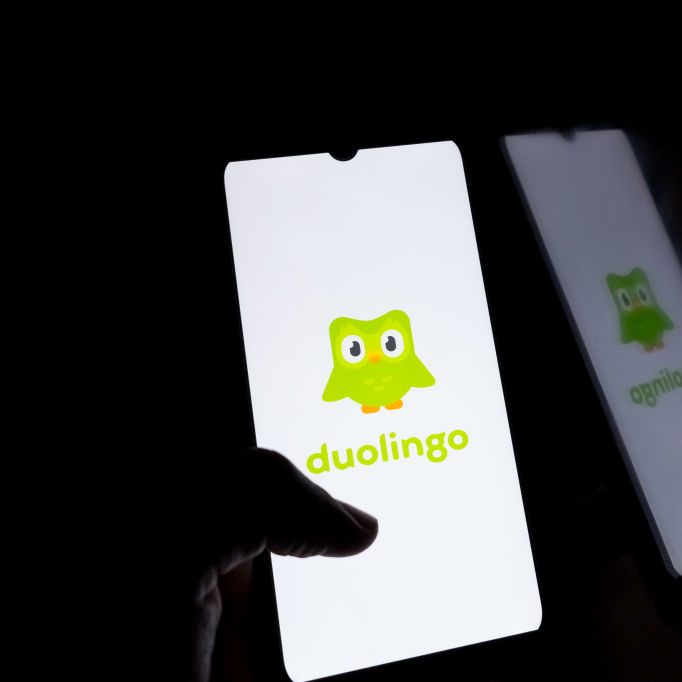 Smartphone showing Duolingo green logo