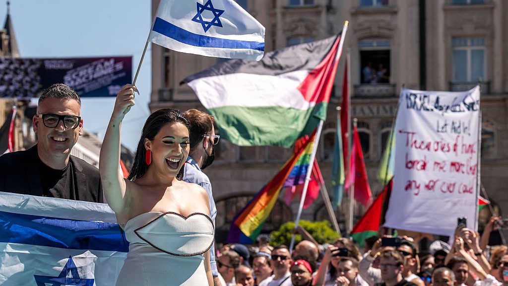 Yuval Raphael (C) representing Israel with the song "New Day Will Rise" arrives on the turquoise carpet next to the Basel Town Hall