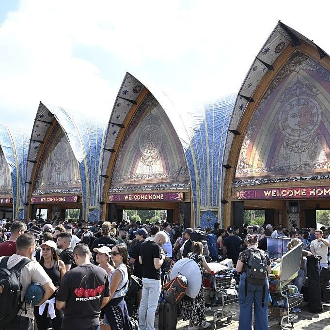 People queue to enter the DreamVille camping site of the Tomorrowland electronic music festival