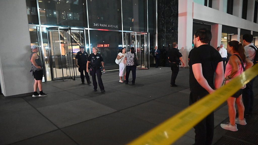 People who sheltered in place exit the building to reunite with loved ones following an attack where five people were shot with four people including NYPD police officer Didarul Islam who was killed in a mass shooting at 345 Park Avenue by suspect Shane Tamura
